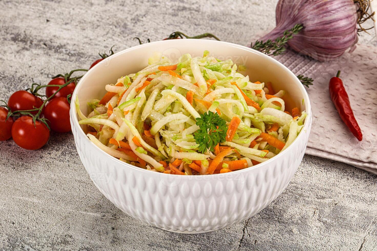 A bowl of salad with carrots and onions photo