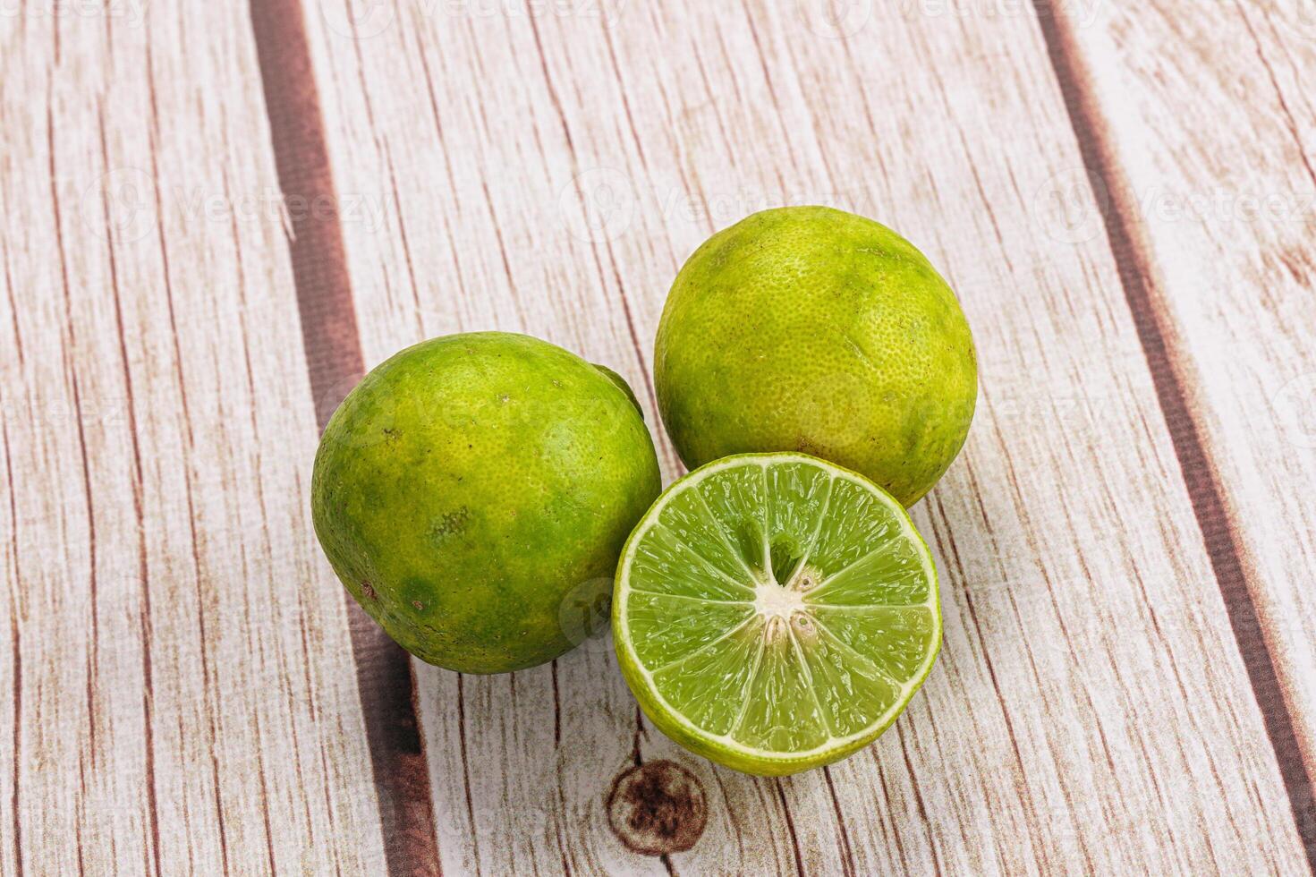 Three limes on a wooden table photo