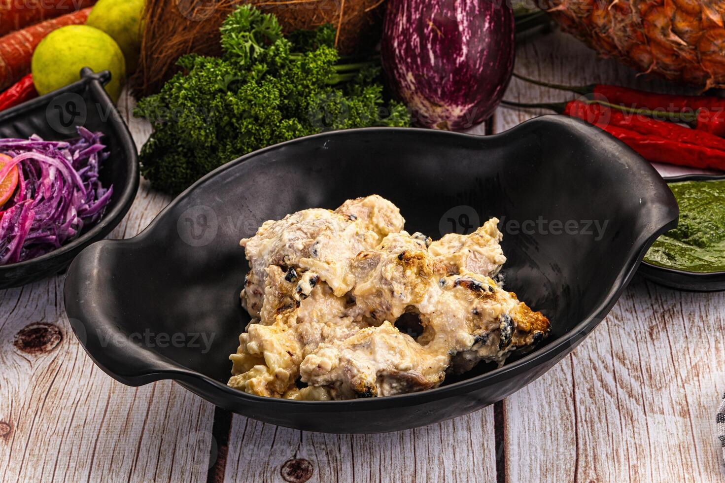 A bowl of food on a table with a knife and spoon photo