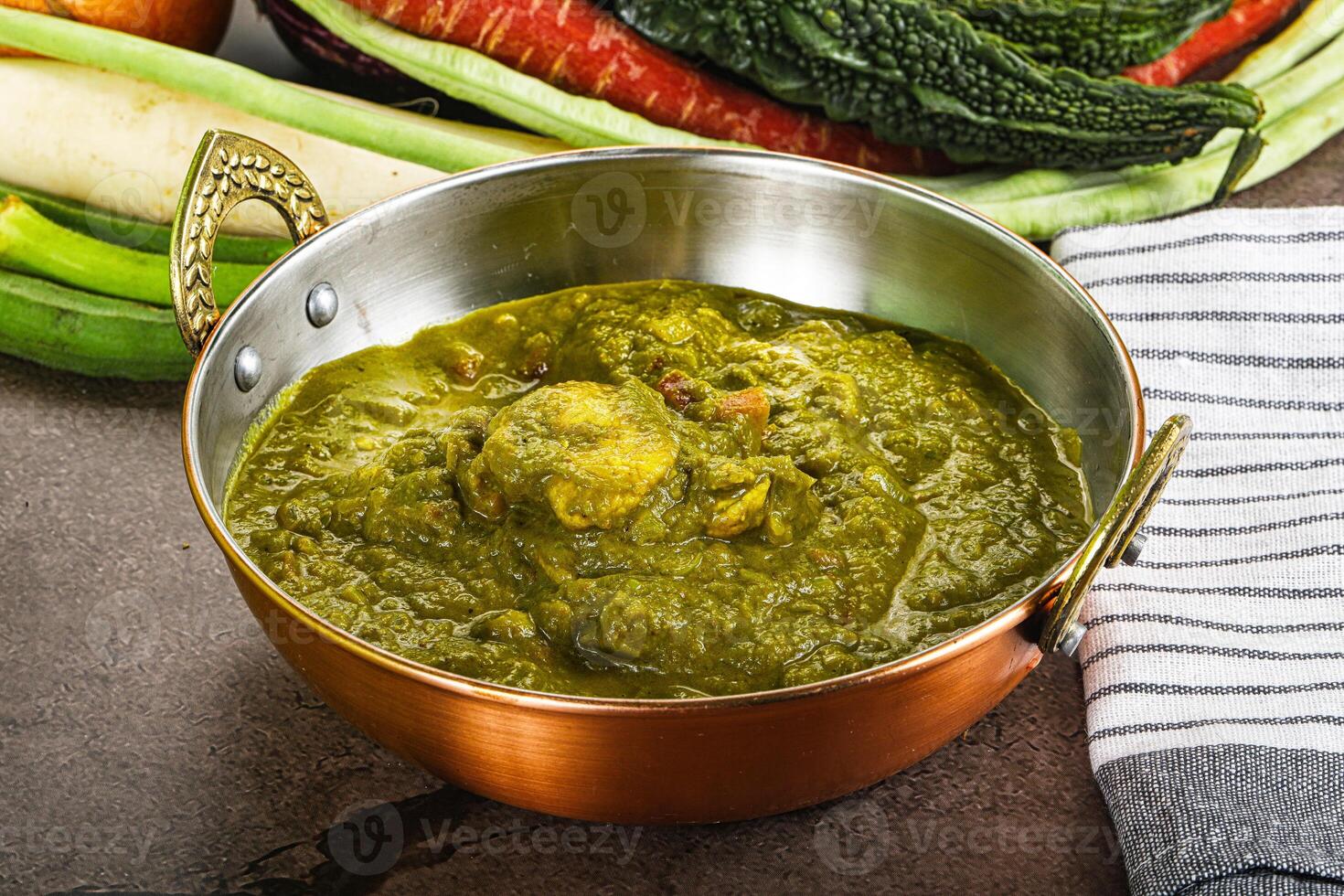 A bowl of green food sitting on a table photo