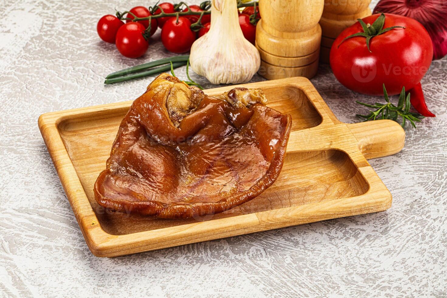 A wooden cutting board with a piece of meat on it photo