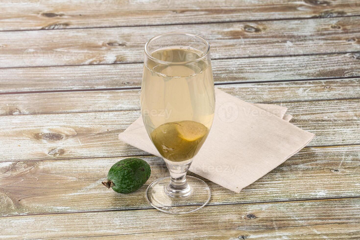 A glass of champagne with an avocado on a napkin photo