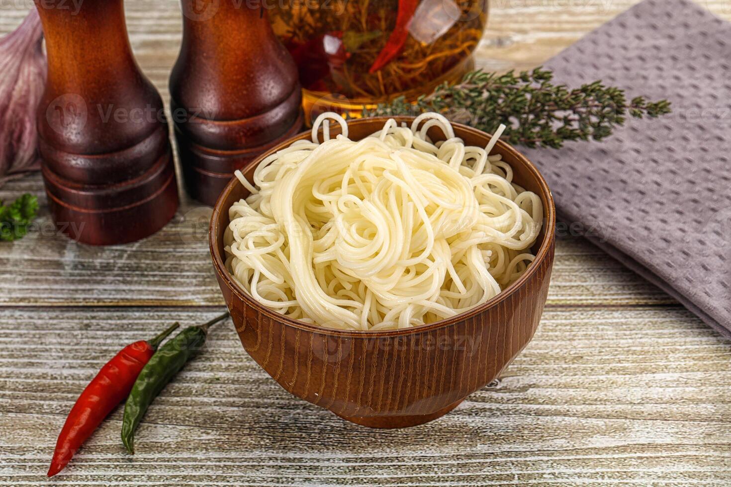 A bowl of noodles with spices and other ingredients photo