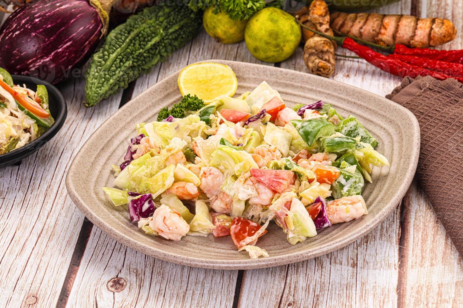 A plate of salad with vegetables and other vegetables photo