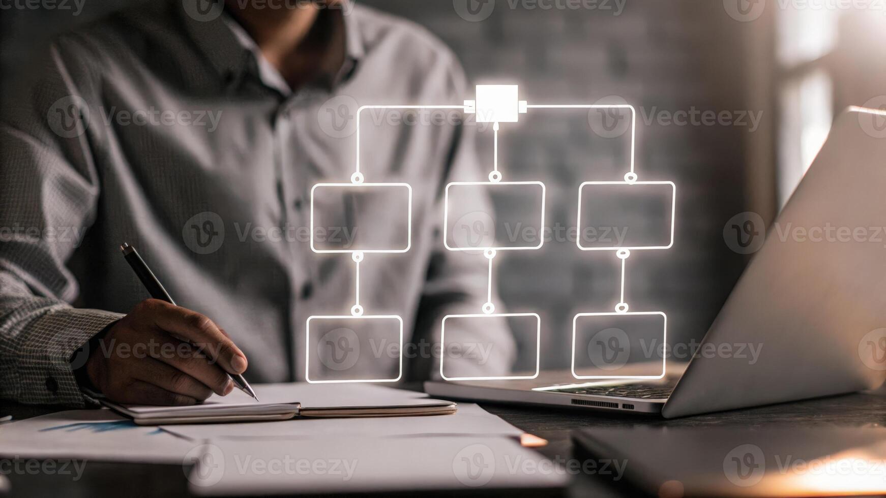A vibrant holographic graph illustrating resource allocation appears above a desk with a person taking notes and considering workload optimization.. photo