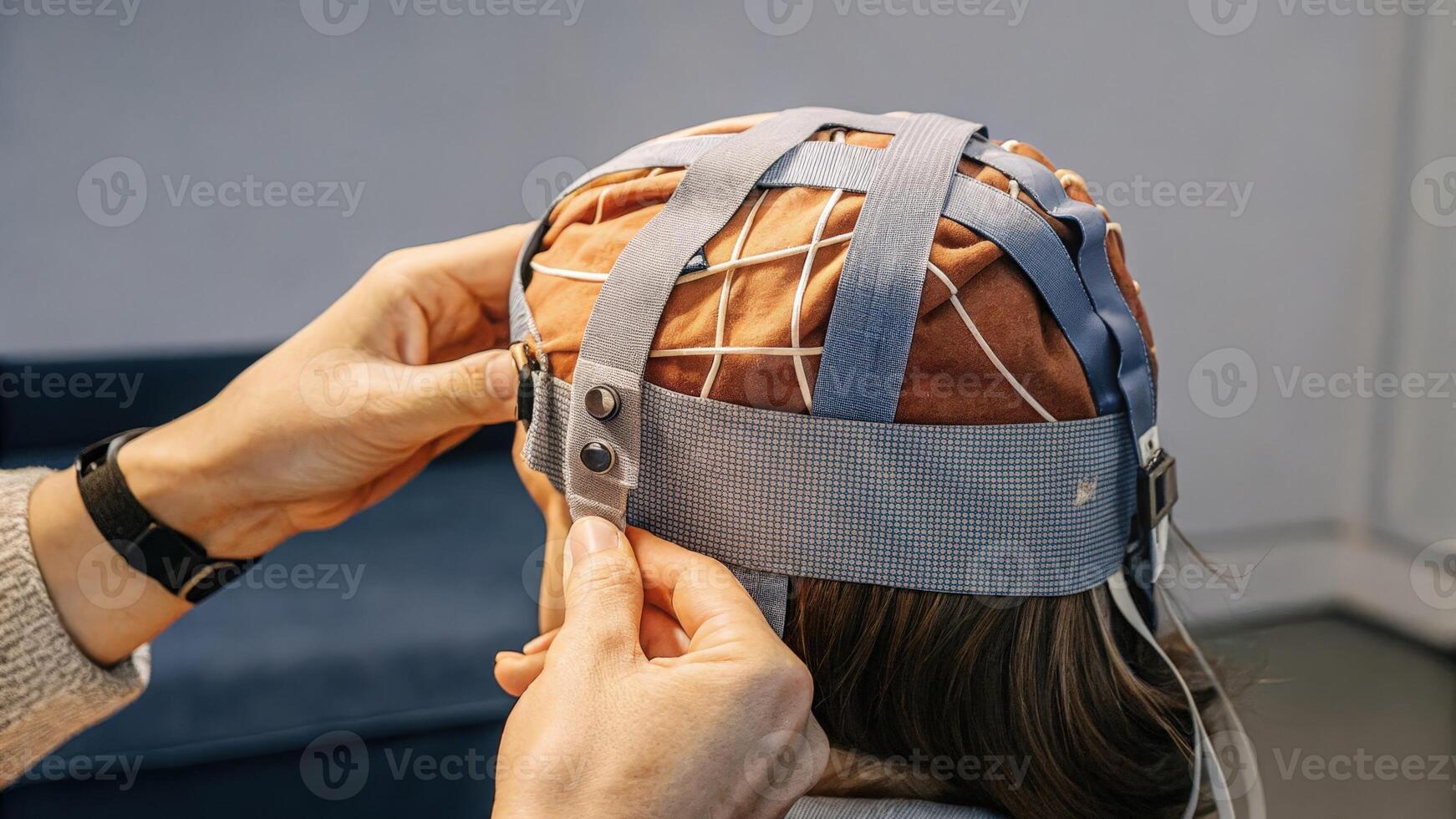 A closeup image of a user adjusting the fit of a DIY EEG cap made from breathable fabric showing the importance of comfort and functionality in wearable brain monitoring. photo