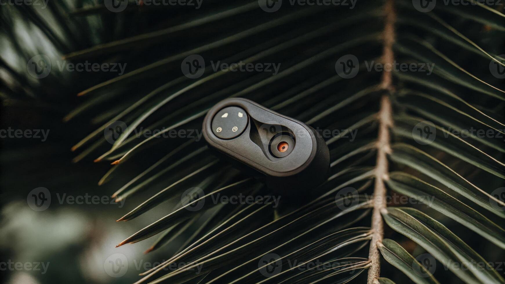 An ergonomic earpiece shaped to fit snugly equipped with brainwavemapping technology designed with a matte finish and showcasing various colorcoded stress indicators.. photo