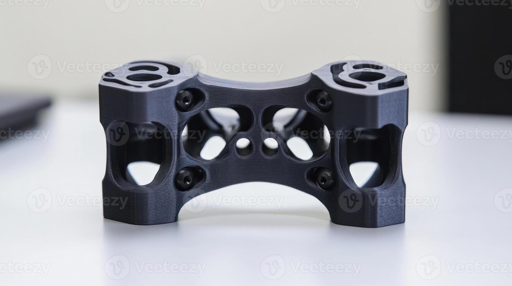 A detailed view of a custom 3Dprinted gimbal bracket featuring complex geometries that provide stability while maintaining minimal weight with visible layering that emphasizes the additiv photo