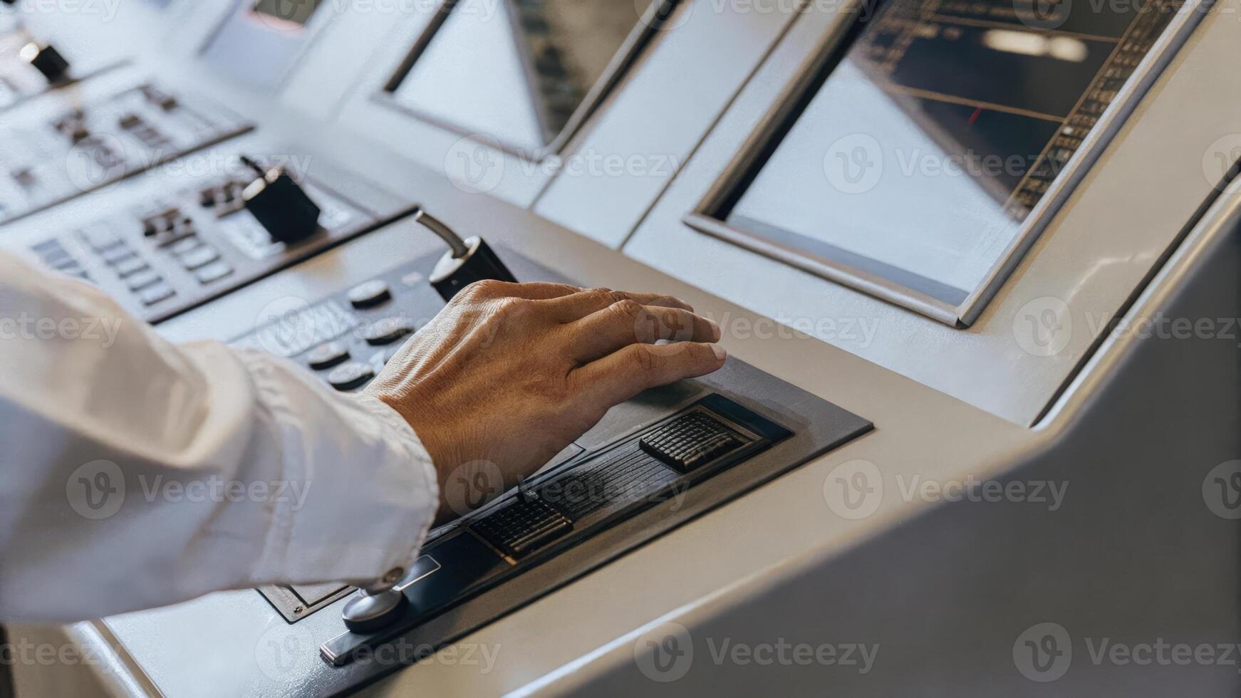Closeup of an individuals hand manipulating a sleek control panel for an advanced cognitive training machine with lights and screens illuminating their determination to enhance. photo