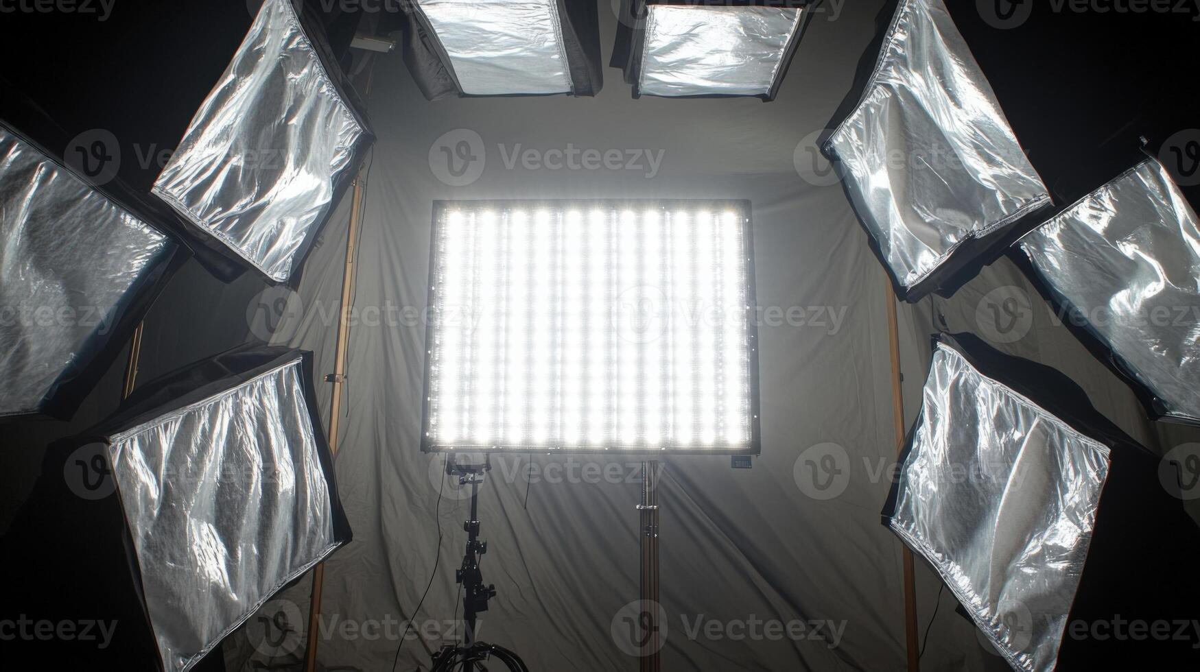 An intricate shot of the softboxs inner lining revealing layers of diffusion material that enhance light quality surrounded by the bright glow of multiple LED panels emitting a sof photo