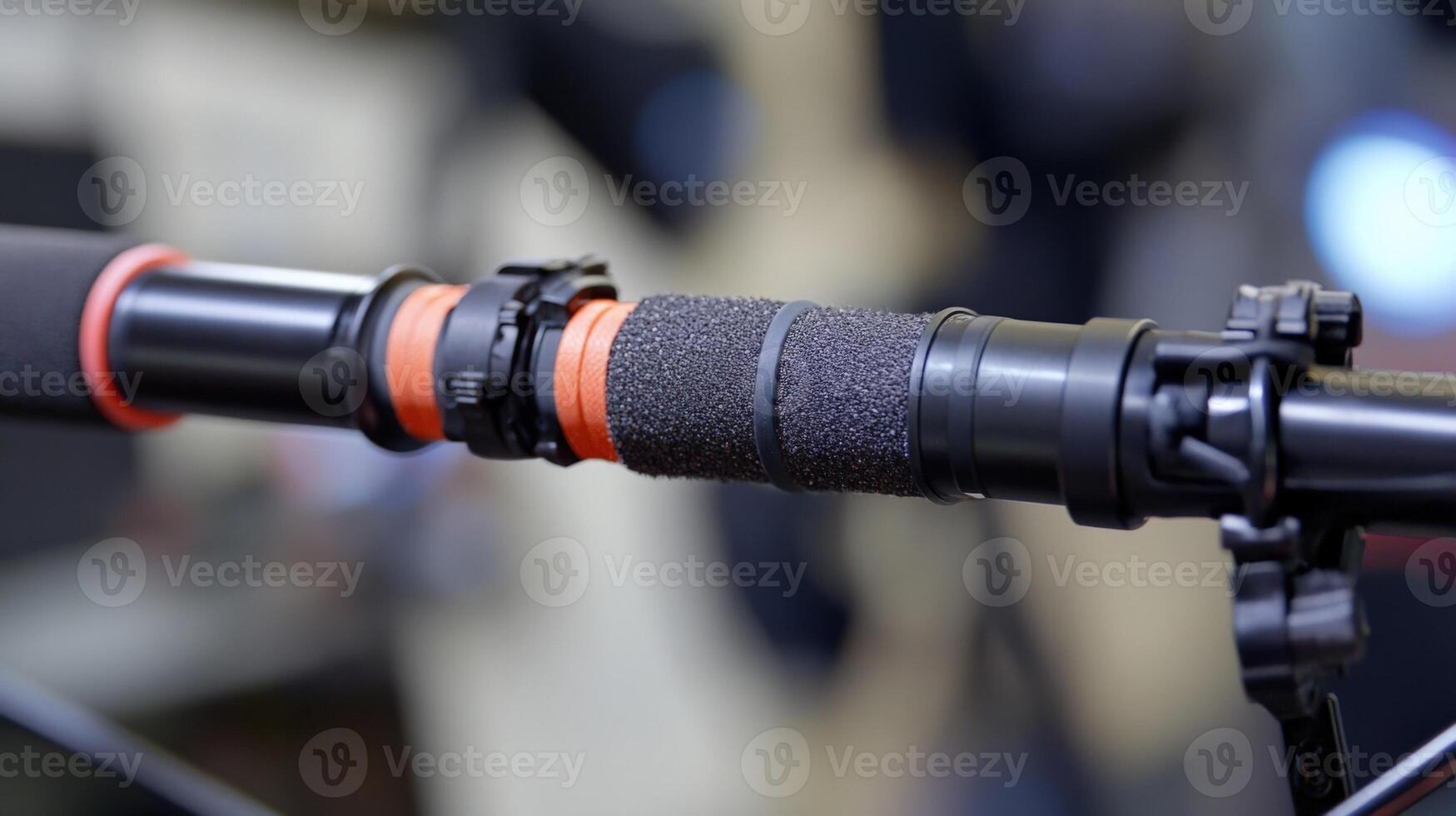 A detailed shot of the boom poles shock mount system revealing multiple layers of foam and elastic bands designed to absorb impacts and vibrations. The mount is securely attached t photo