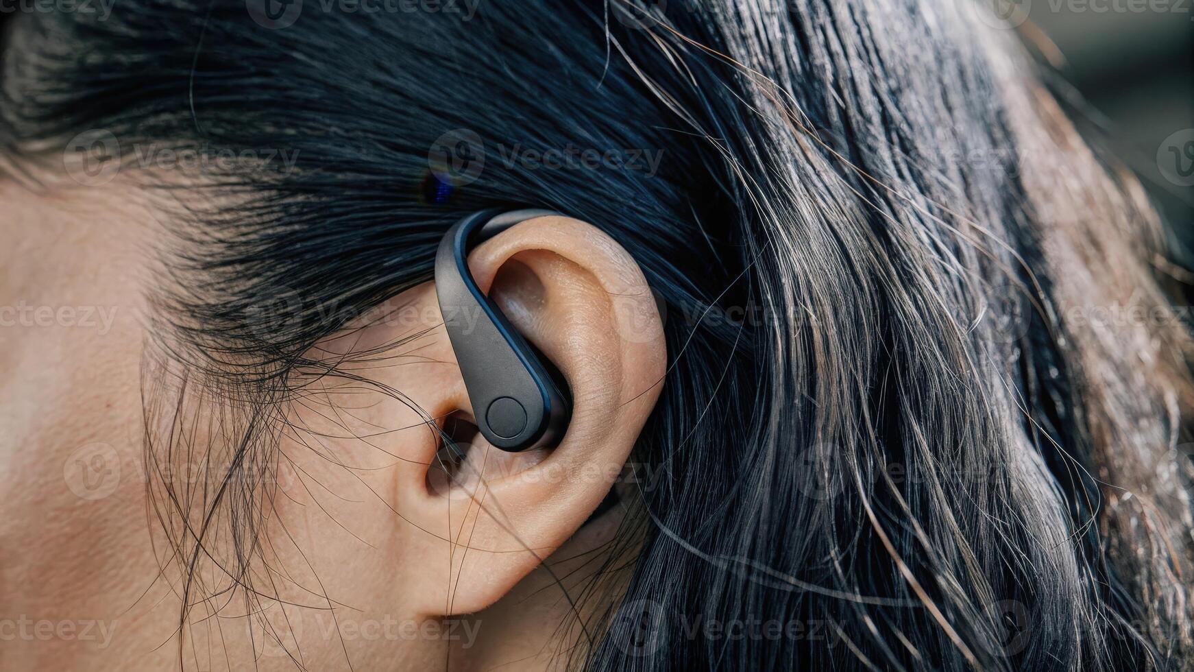 An earpiece equipped with a tiny biosensor that measures brainwave activity. The device blends seamlessly into the ear showcasing an intricate network of sensors and electrodes. photo