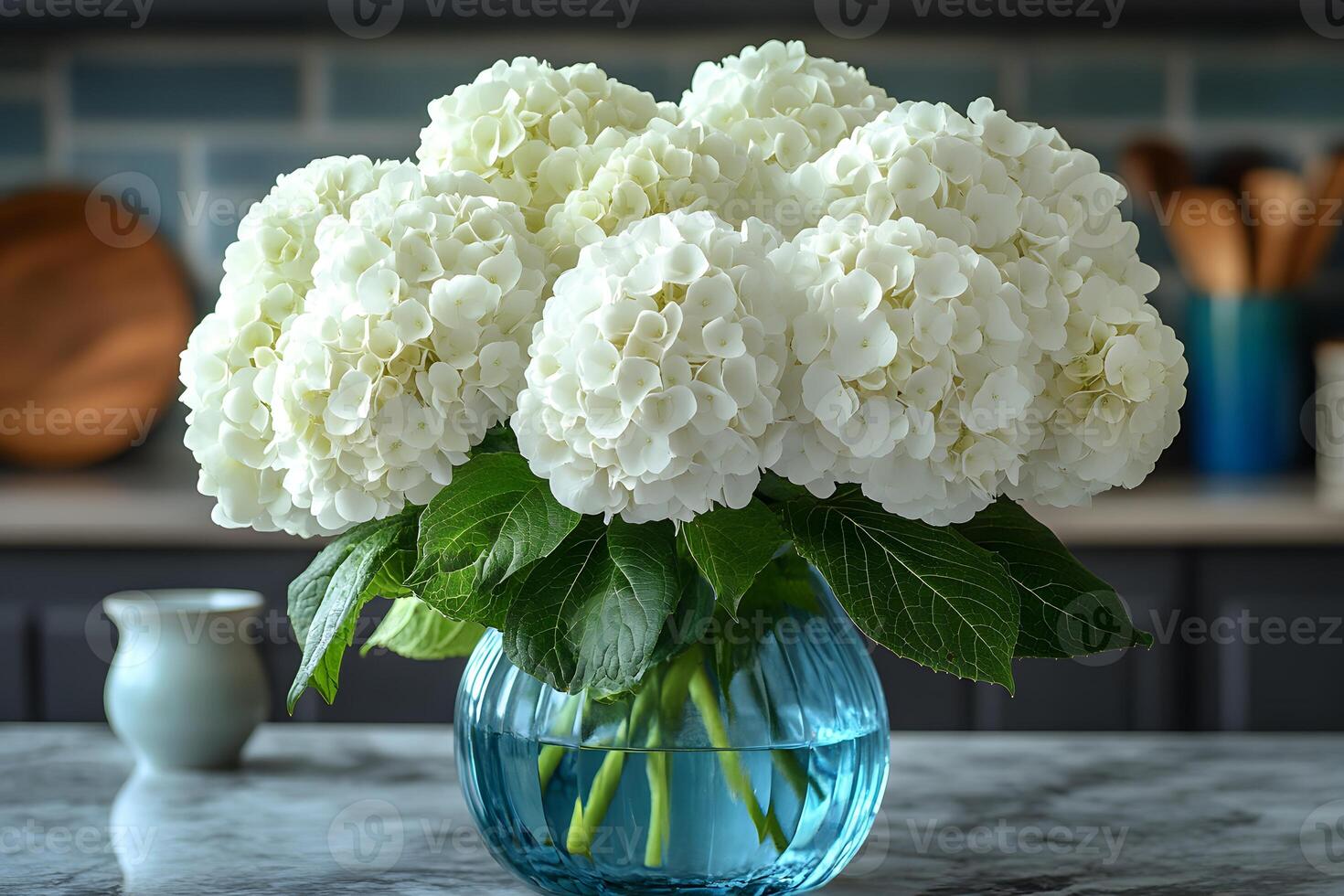 Elegant White Hydrangeas in Blue Glass Vase for Home Decor and Floral Design photo