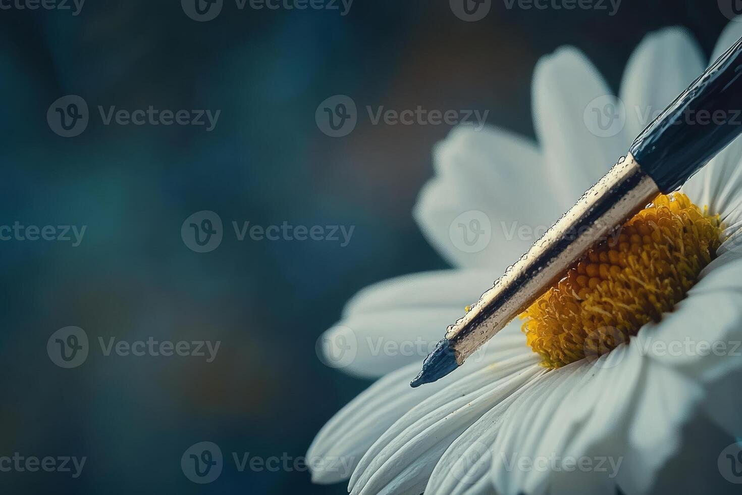 A pen is resting on a white flower photo