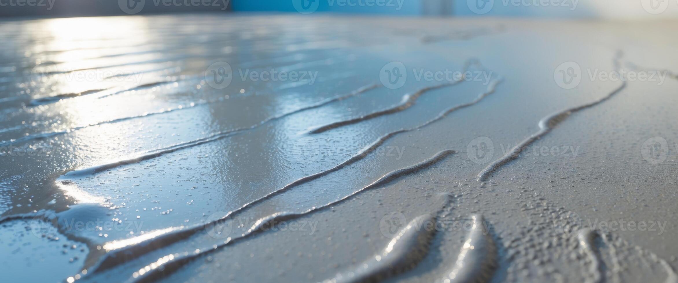 Wet cement with a glossy surface reflecting a bright background photo