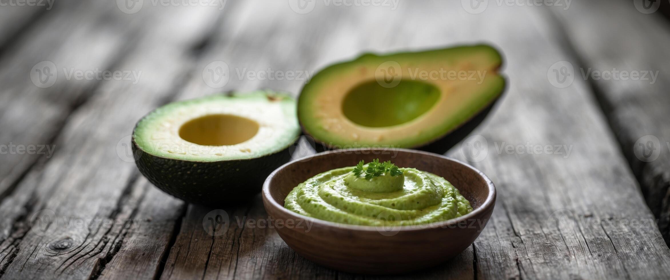 Freshly Sliced Avocado with Creamy Dip on Rustic Wooden Table. photo