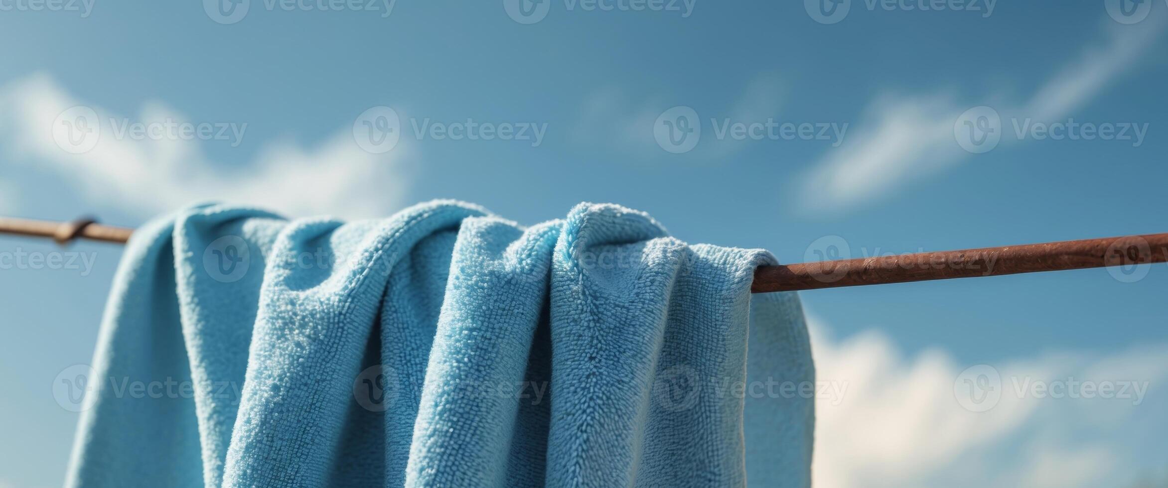 Soft Blue Towel Hanging on Clothesline Under Clear Sky. photo