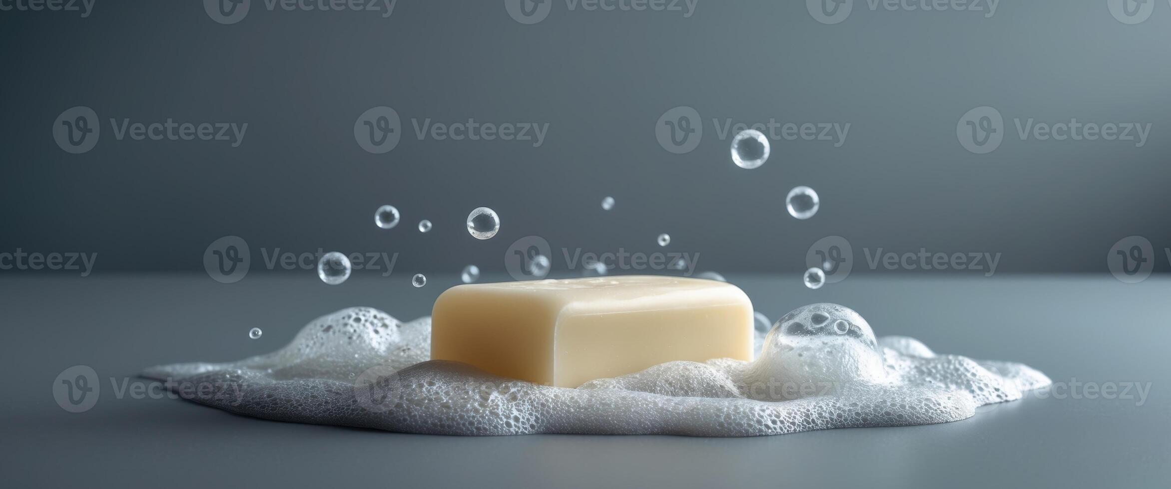 Soap bar with lathered bubbles on gray surface for personal hygiene concept. photo