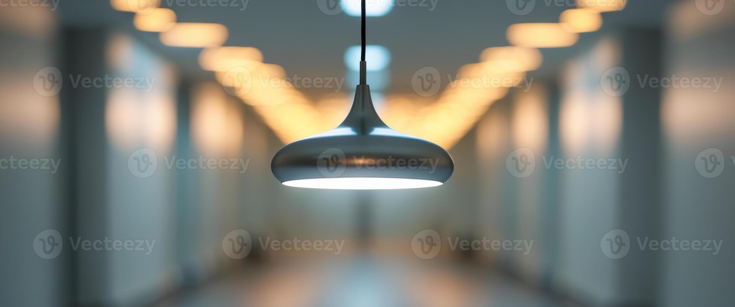 Lit pendant lamp in hallway with blurred background lights photo
