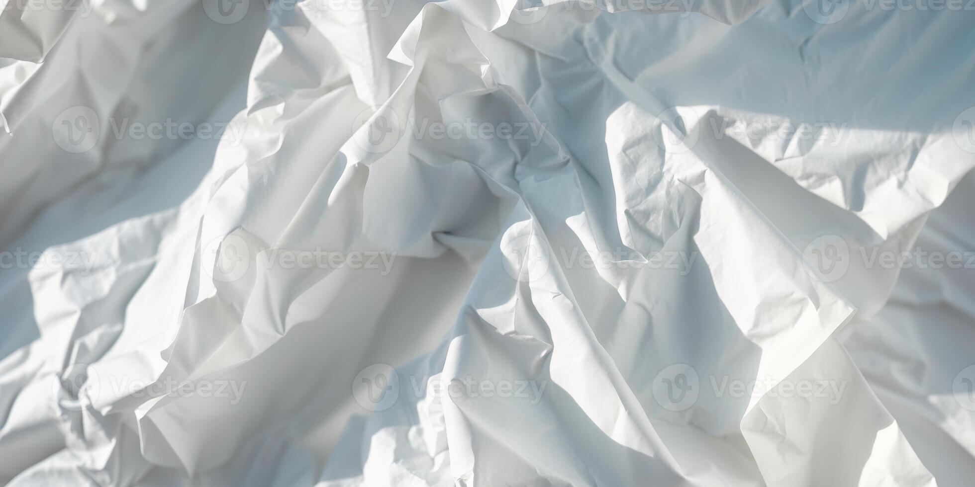 White crumpled paper forming an abstract background with intriguing shapes and shadows. photo
