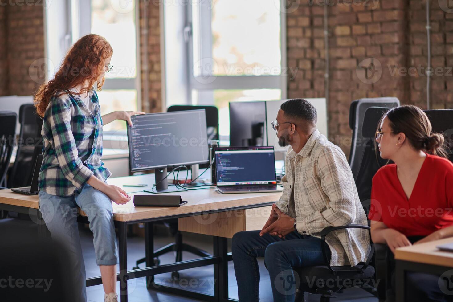 A diverse group of young business individuals congregates in a modern startup coworking center, embodying collaborative innovation and a dynamic atmosphere. photo