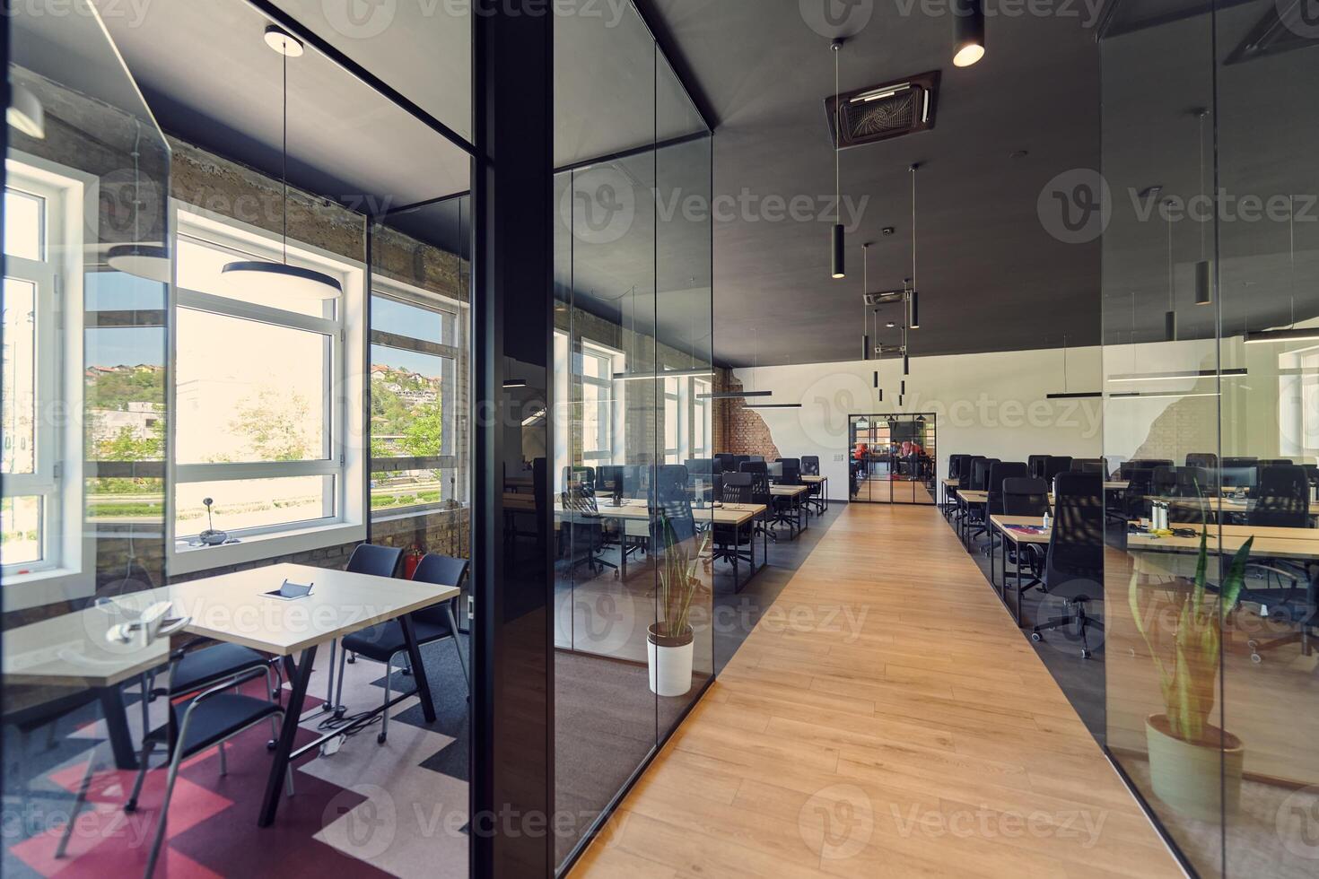 In a setting of modern, glass-walled business startup offices, the open, airy workspace reflects a contemporary and innovative ambiance, promising a dynamic environment for entrepreneurial growth photo