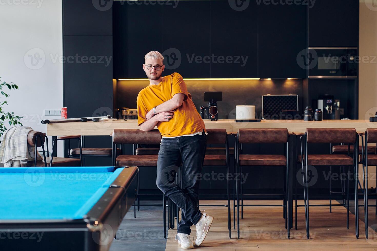 A man takes a brief rest from work in a modern startup coworking center, using the moment to recharge and relax with technology by his side. photo
