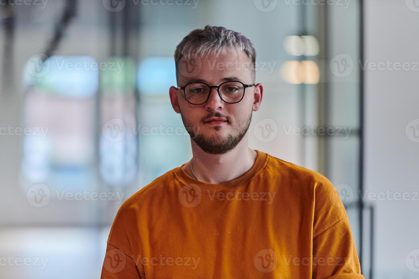 A modern portrait captures a blue-haired businessman wearing glasses, exuding creativity and professionalism, within the ambiance of a startup coworking office photo
