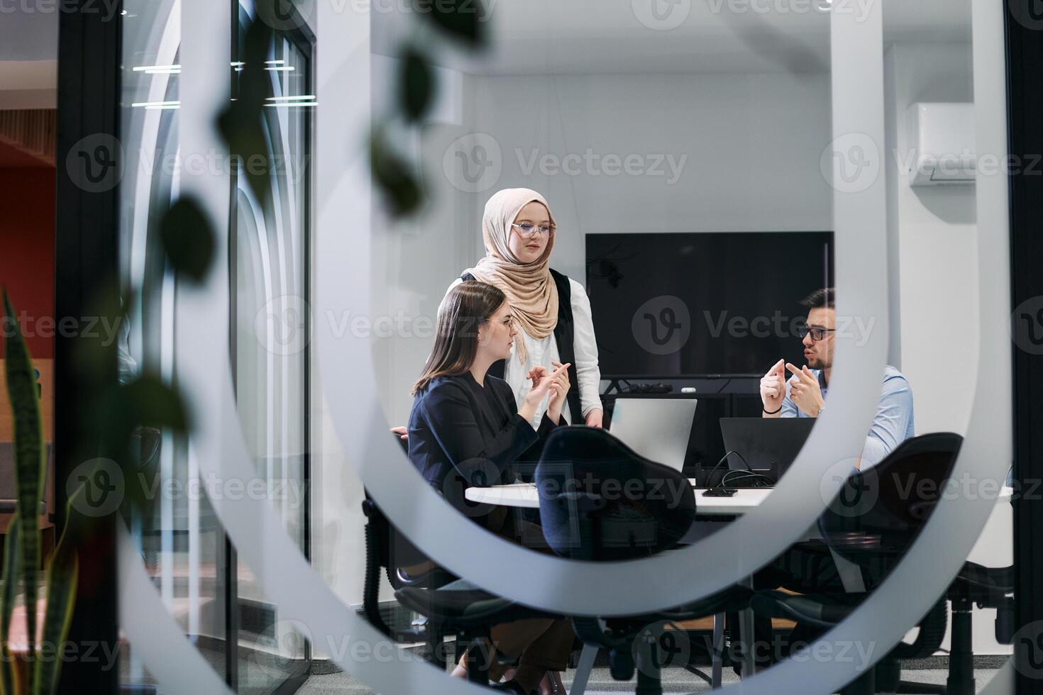 A diverse group of businessmen collaborates and tests a new virtual reality technology, wearing virtual glasses, showcasing innovation and creativity in their futuristic workspace photo