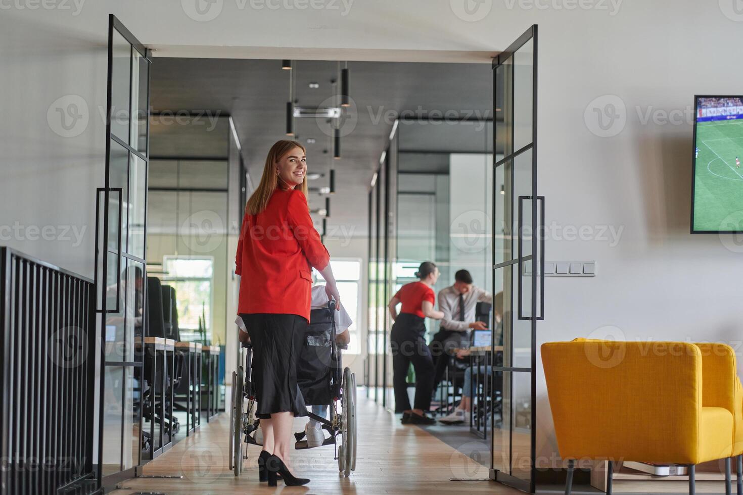 A group of young business people in a modern glass-walled office captures the essence of diversity and collaboration, while two colleagues, including an African American businessman in a wheelchair photo