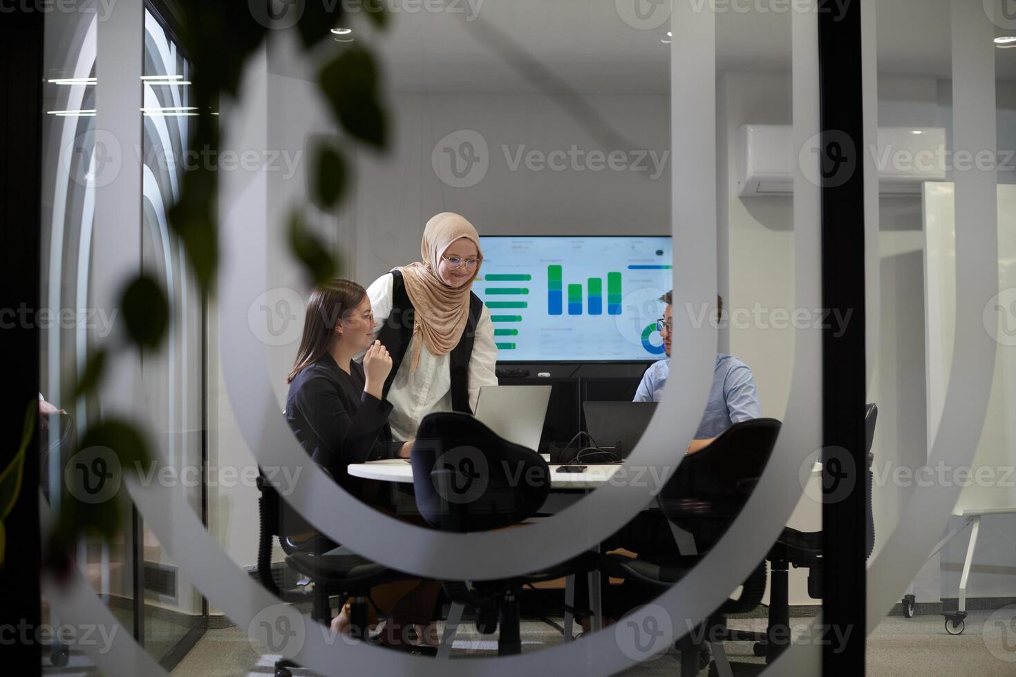 A diverse group of businessmen collaborates and tests a new virtual reality technology, wearing virtual glasses, showcasing innovation and creativity in their futuristic workspace photo