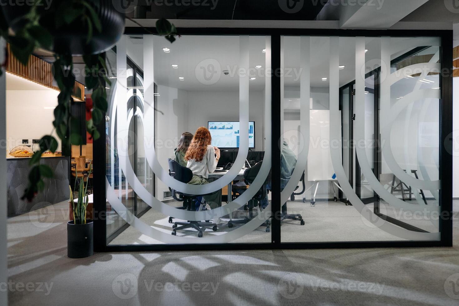 A diverse group of businessmen collaborates and tests a new virtual reality technology, wearing virtual glasses, showcasing innovation and creativity in their futuristic workspace photo
