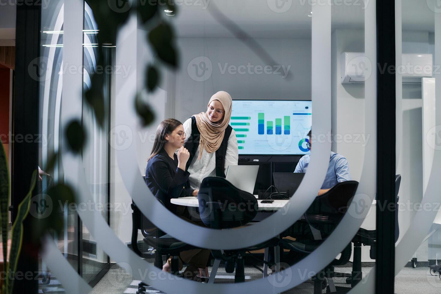 A diverse group of businessmen collaborates and tests a new virtual reality technology, wearing virtual glasses, showcasing innovation and creativity in their futuristic workspace photo