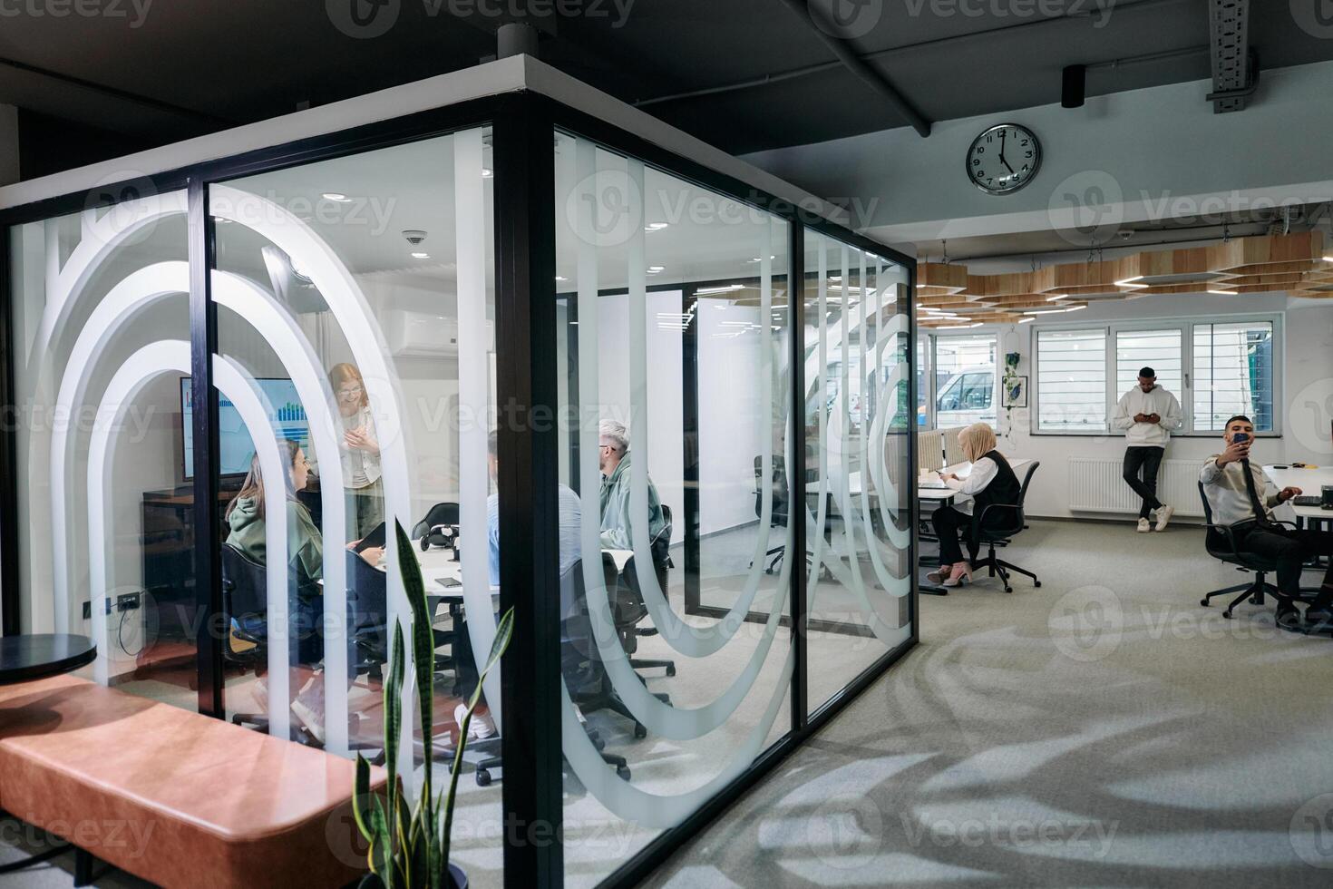 A diverse group of businessmen collaborates and tests a new virtual reality technology, wearing virtual glasses, showcasing innovation and creativity in their futuristic workspace photo