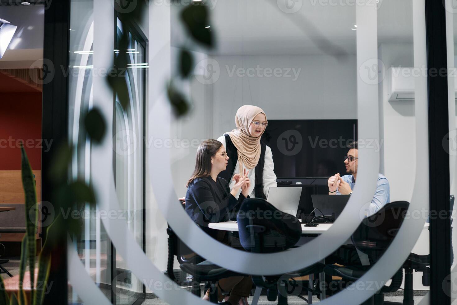 A diverse group of businessmen collaborates and tests a new virtual reality technology, wearing virtual glasses, showcasing innovation and creativity in their futuristic workspace photo