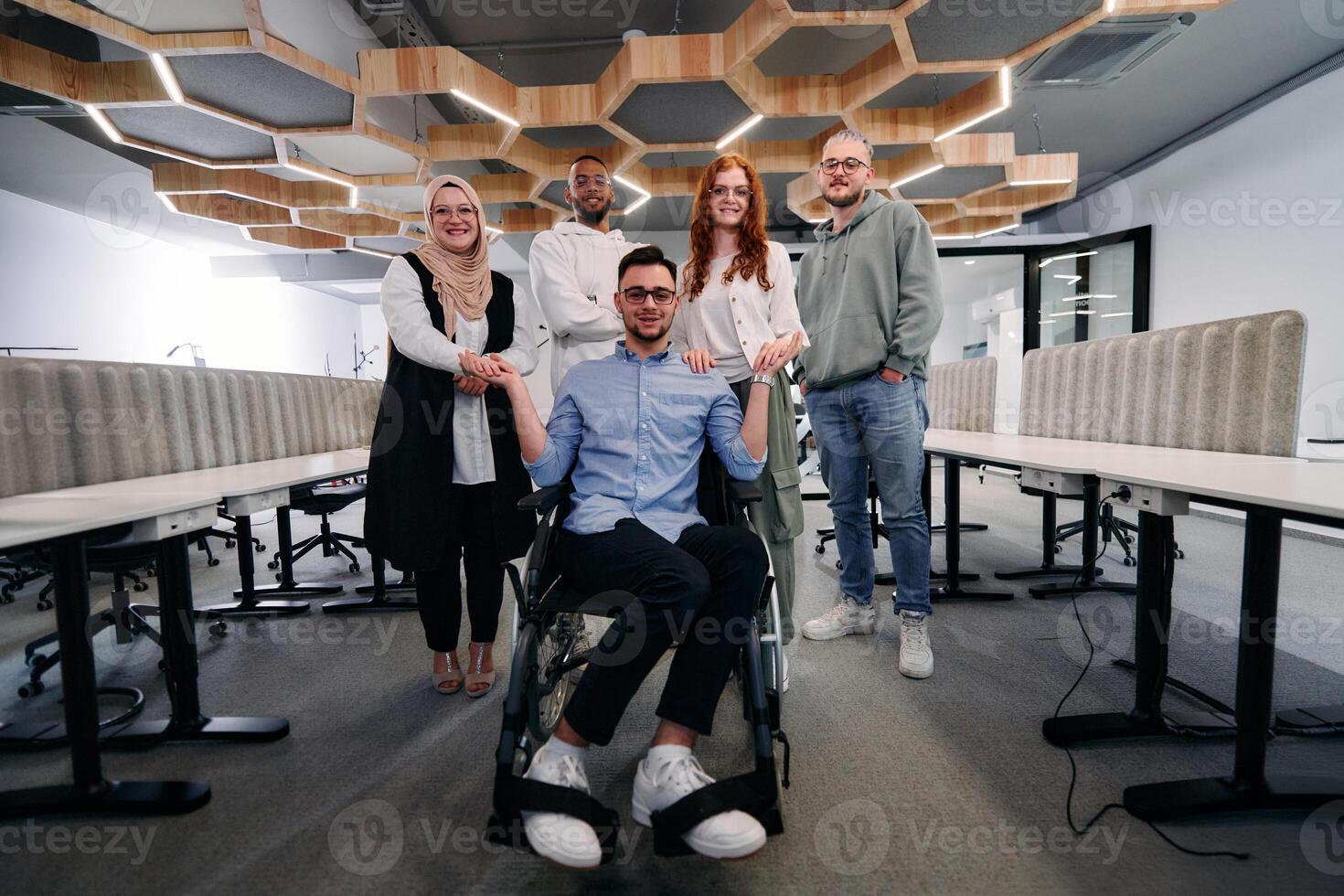 Young businessmen in a modern office extend a handshake to their business colleague in a wheelchair, showcasing inclusivity, support, and unity in the corporate environment. photo