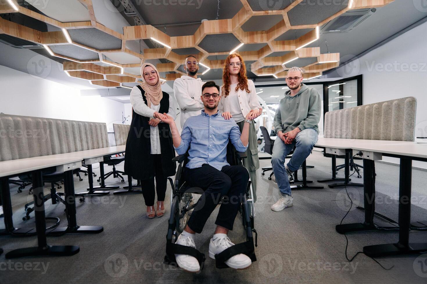 Young businessmen in a modern office extend a handshake to their business colleague in a wheelchair, showcasing inclusivity, support, and unity in the corporate environment. photo