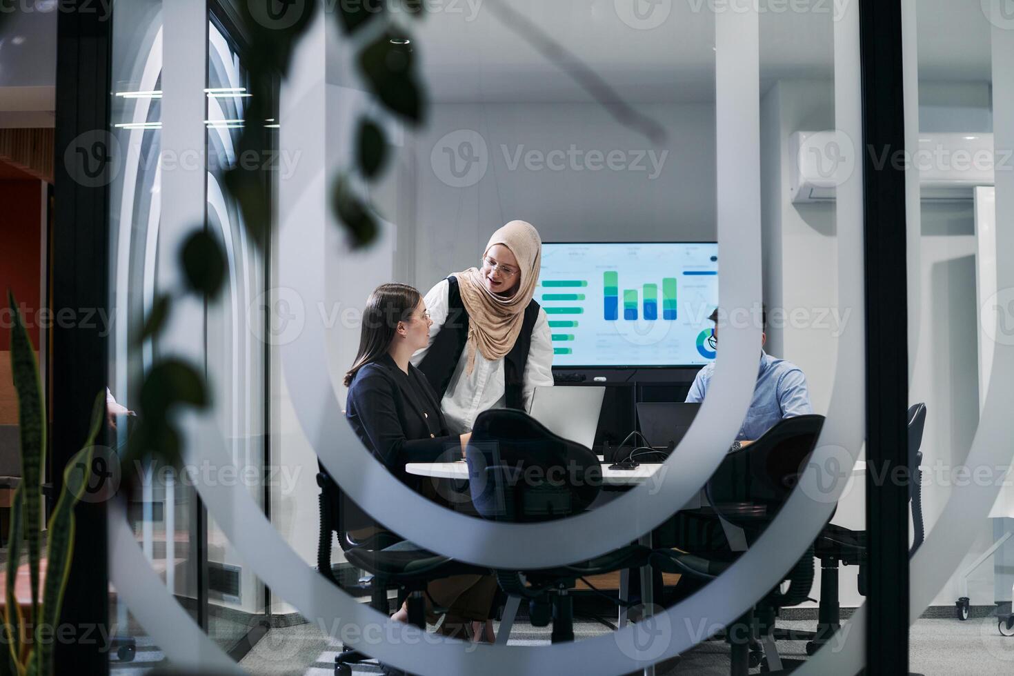 A diverse group of businessmen collaborates and tests a new virtual reality technology, wearing virtual glasses, showcasing innovation and creativity in their futuristic workspace photo