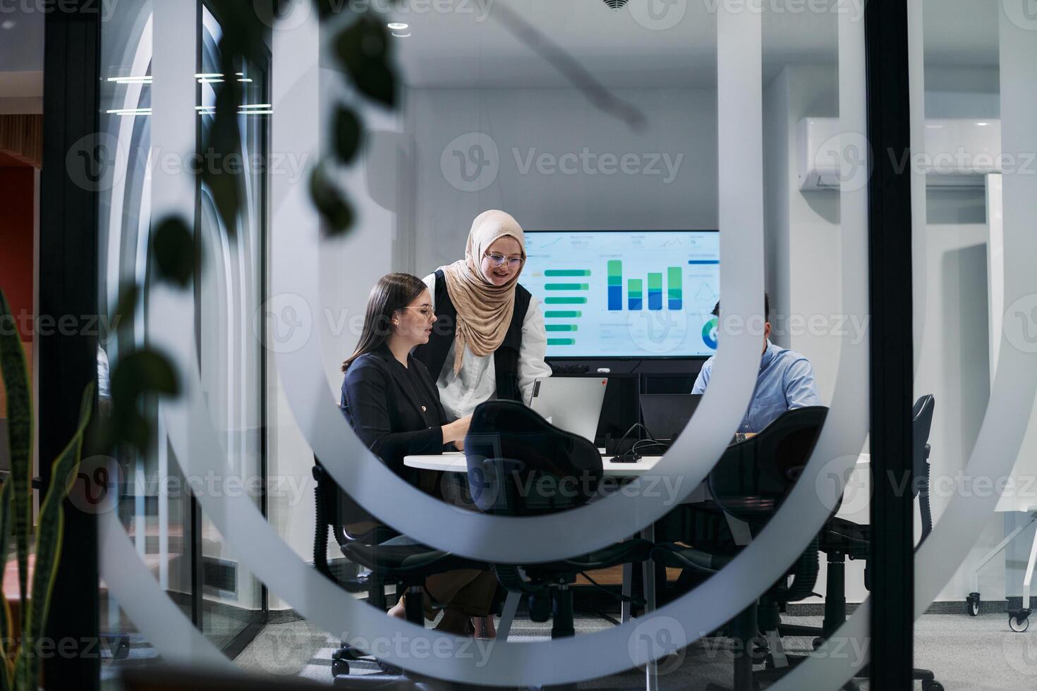 A diverse group of businessmen collaborates and tests a new virtual reality technology, wearing virtual glasses, showcasing innovation and creativity in their futuristic workspace photo