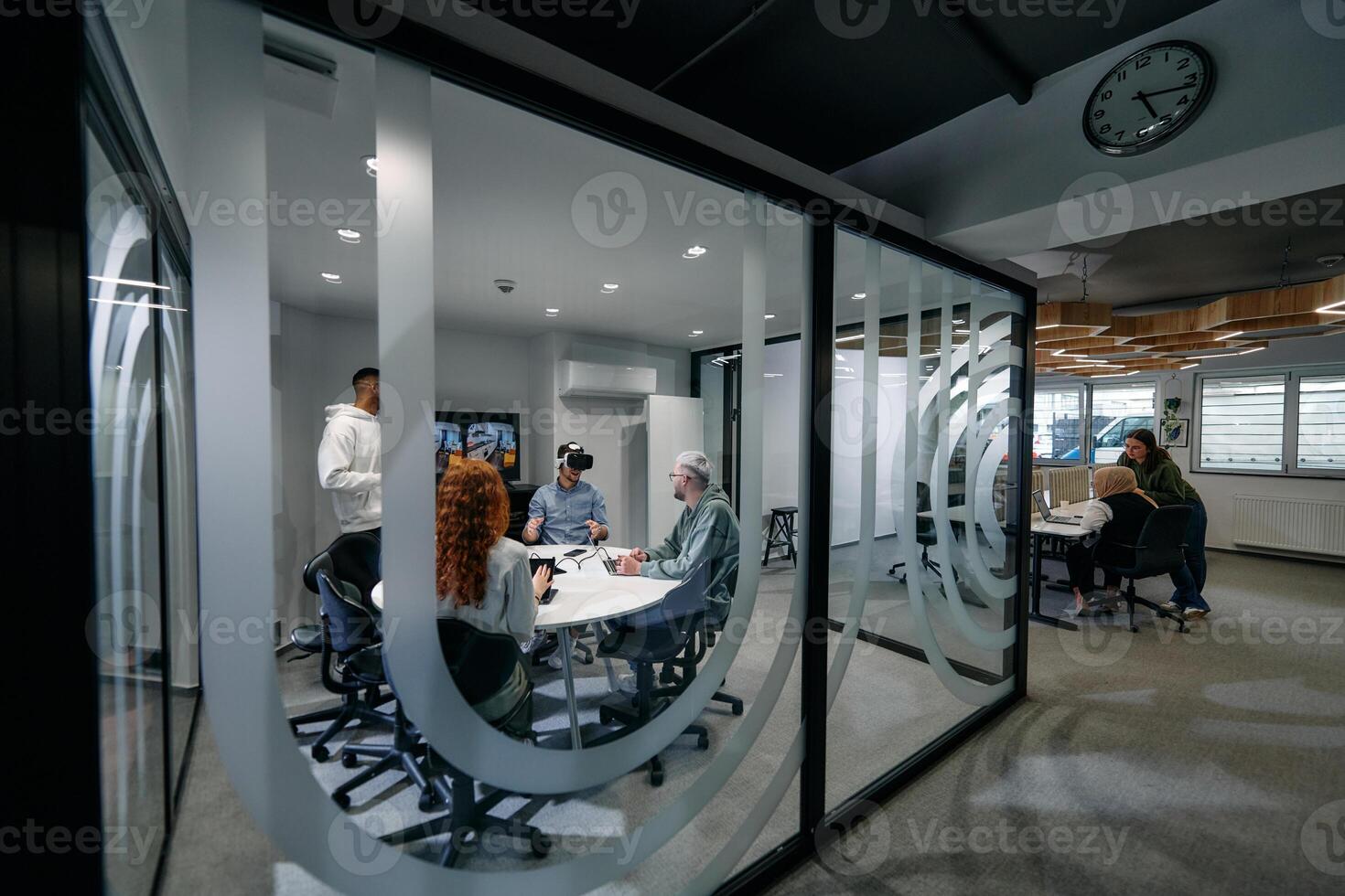 A diverse group of businessmen collaborates and tests a new virtual reality technology, wearing virtual glasses, showcasing innovation and creativity in their futuristic workspace photo