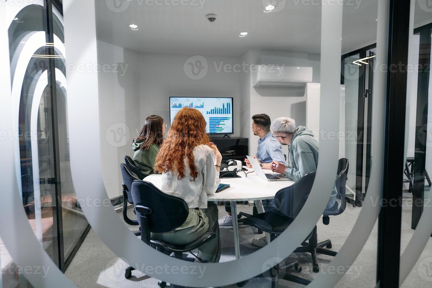 A diverse group of businessmen collaborates and tests a new virtual reality technology, wearing virtual glasses, showcasing innovation and creativity in their futuristic workspace photo