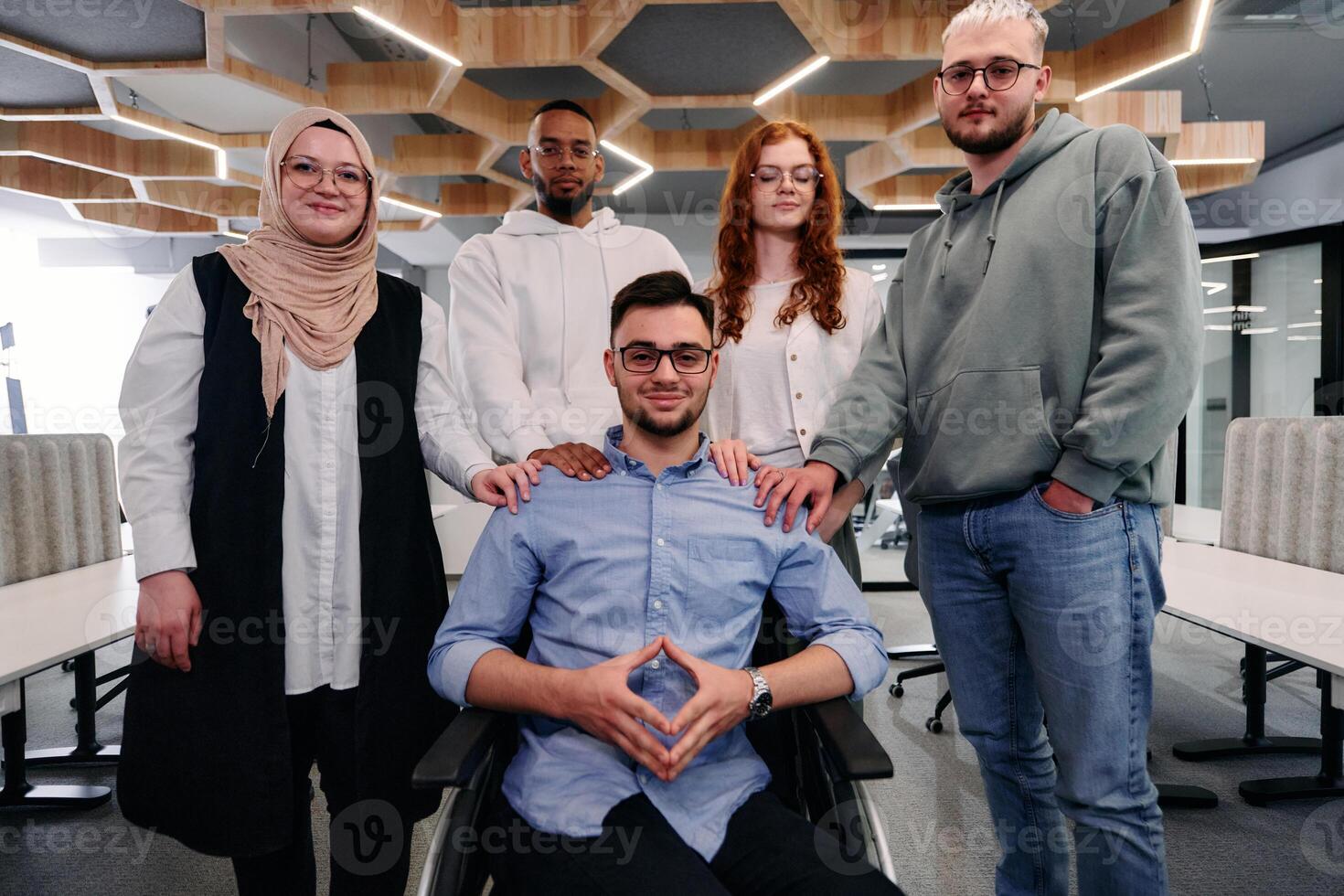 Young businessmen in a modern office extend a handshake to their business colleague in a wheelchair, showcasing inclusivity, support, and unity in the corporate environment. photo