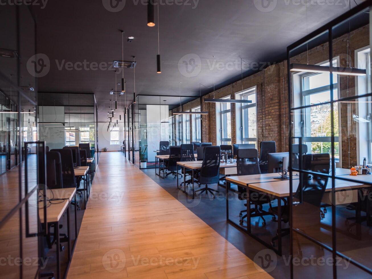 In a setting of modern, glass-walled business startup offices, the open, airy workspace reflects a contemporary and innovative ambiance, promising a dynamic environment for entrepreneurial growth photo