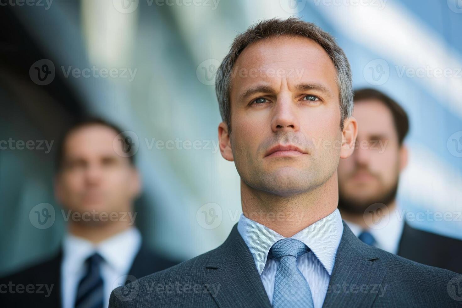 Confident business leaders stand together in a modern urban setting with a focus on their leadership presence and teamwork photo