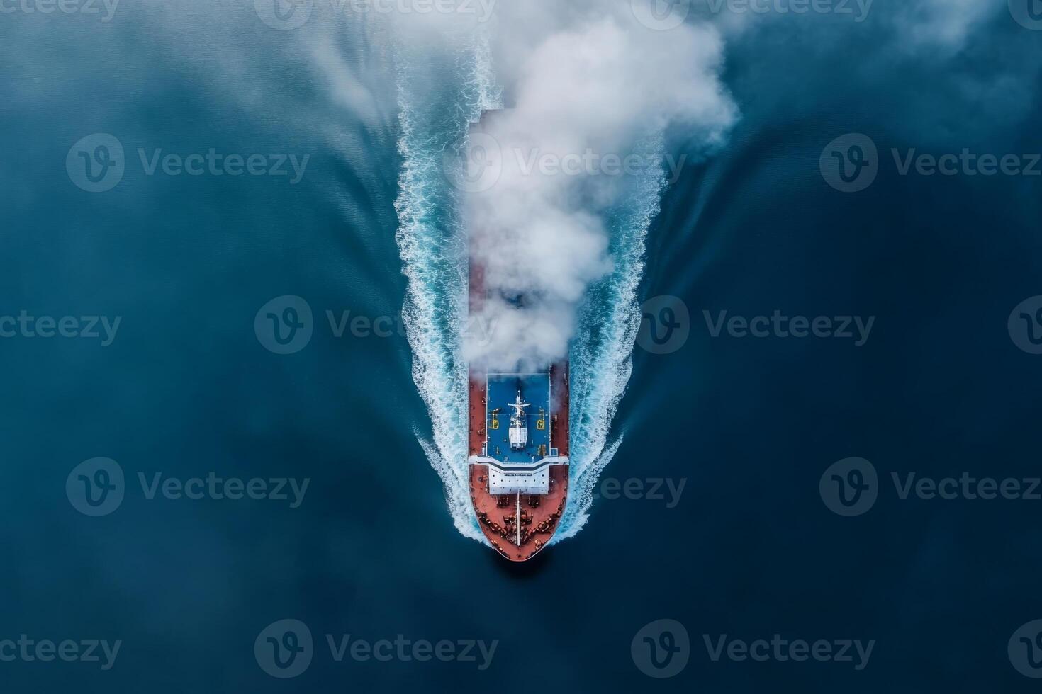 Large cargo ship navigates through ocean waters creating waves and mist during daylight photo