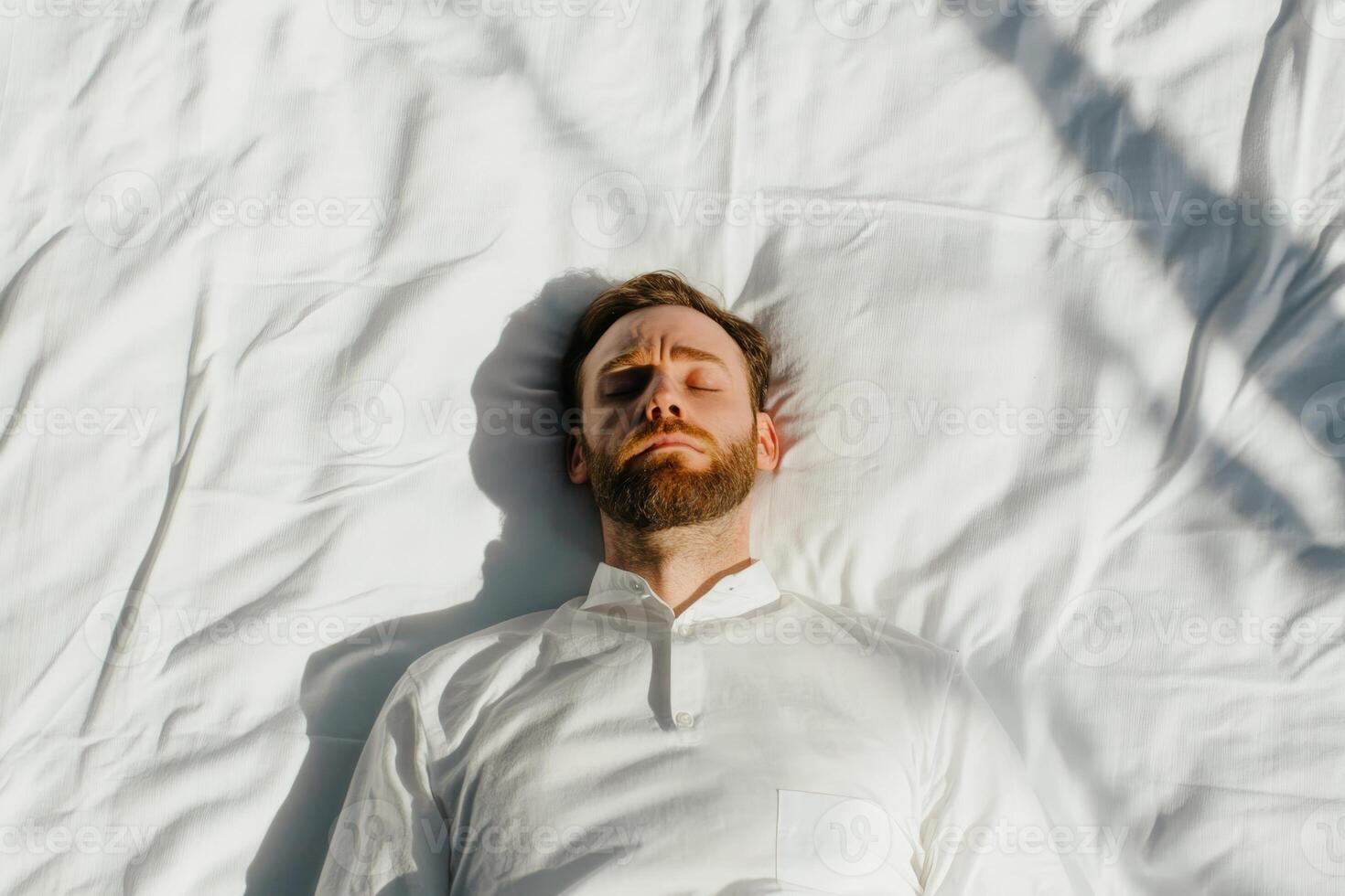 Man resting with eyes closed on a white in a bright and serene environment during daytime photo