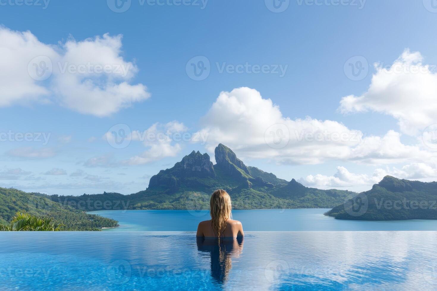Relaxing in a serene infinity pool with stunning mountain views at a tropical paradise resort photo