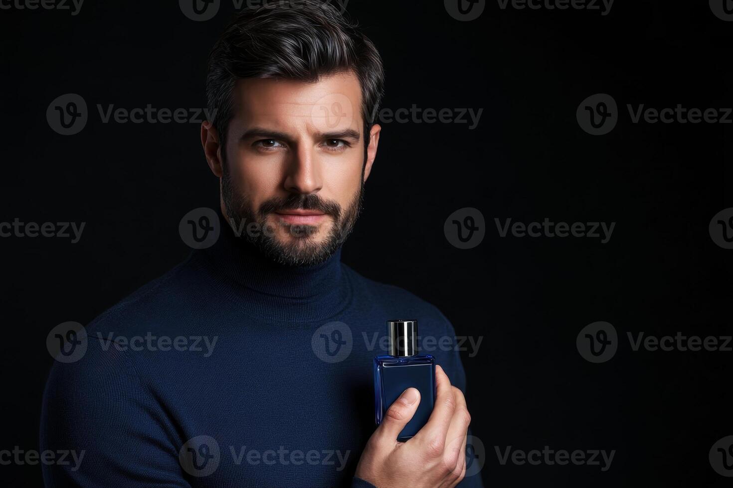 Man holding a fragrance bottle while wearing a dark turtleneck in a studio setting photo