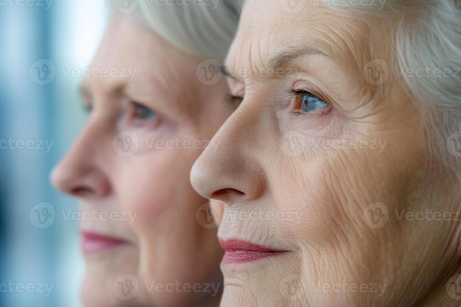 Senior women reflecting quietly while looking through a window in a bright indoor space during daytime photo