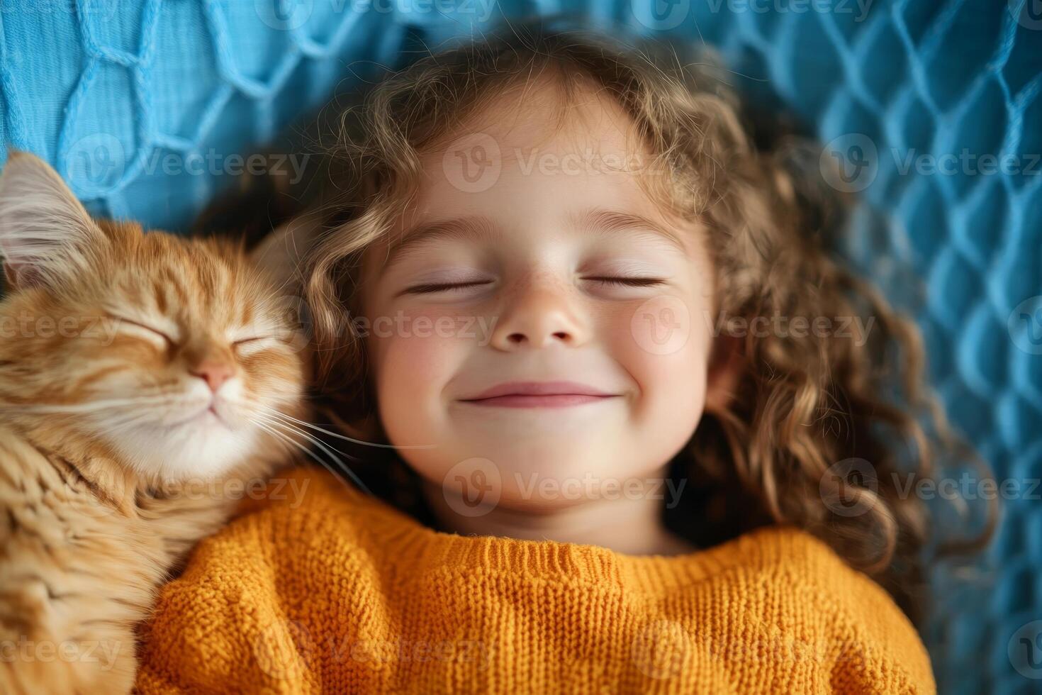 Happy child and orange cat relaxing together in a cozy setting with smiles and warmth photo